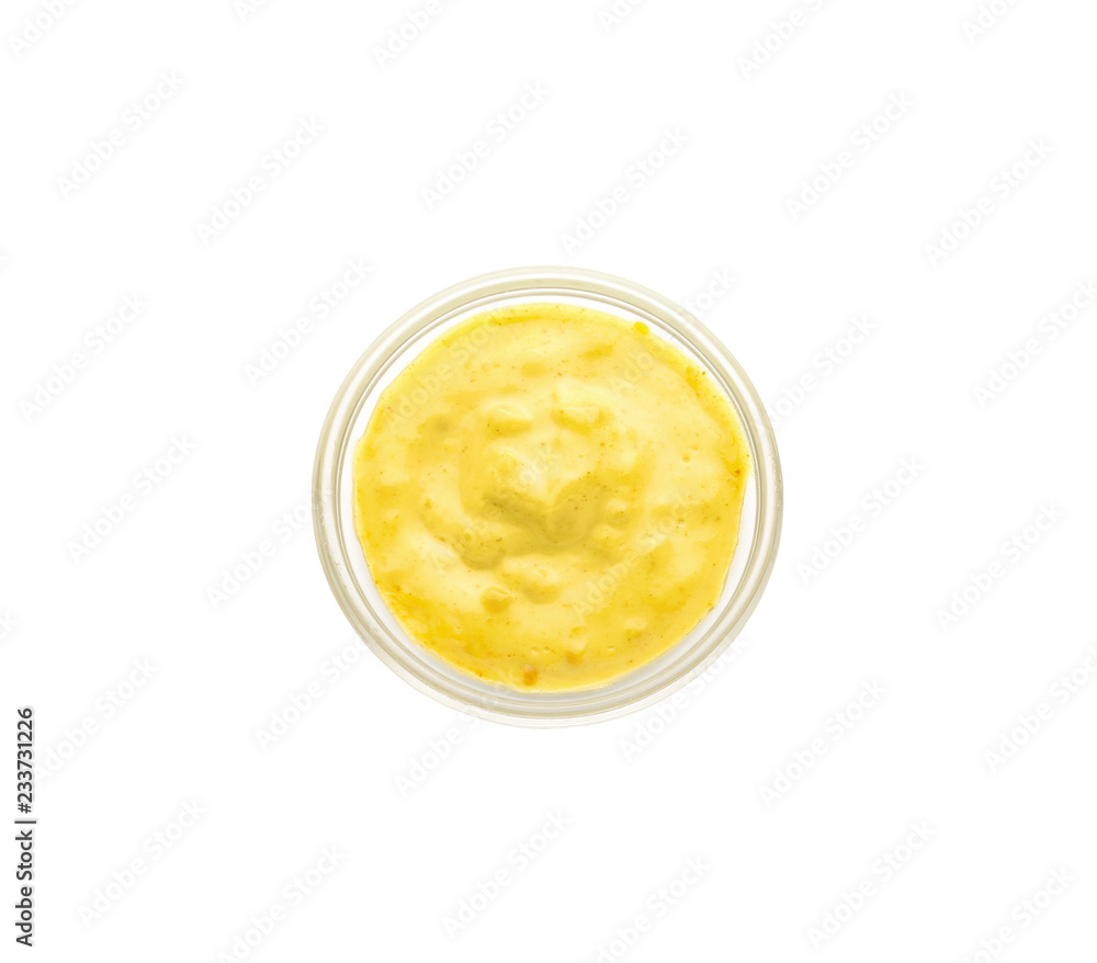 Tasty yellow sauce in bowl on white background Tasty yellow sauce in bowl on white background