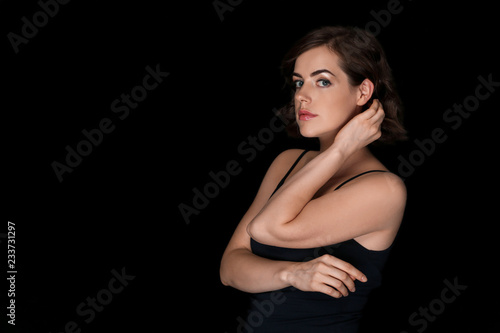 Portrait of beautiful young woman on dark background