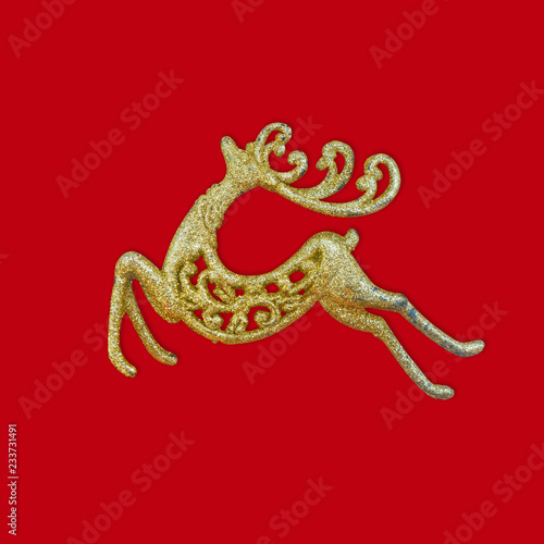 Golden Reindeer on red background with copy space. New year, Christmas concept