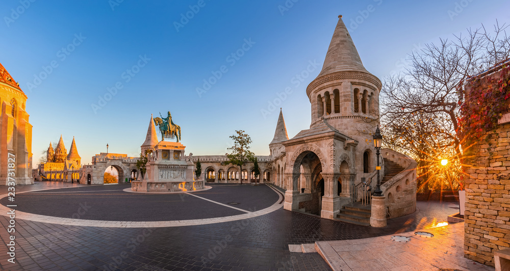 Fototapeta premium Budapest, Hungary - Panoramic view of the Fisherman's Bastion (Halaszbastya) at sunrise with autumn foliage and clear blue sky