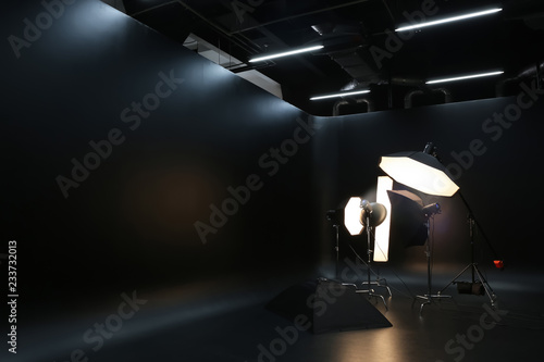 Interior of modern photo studio with professional lighting equipment