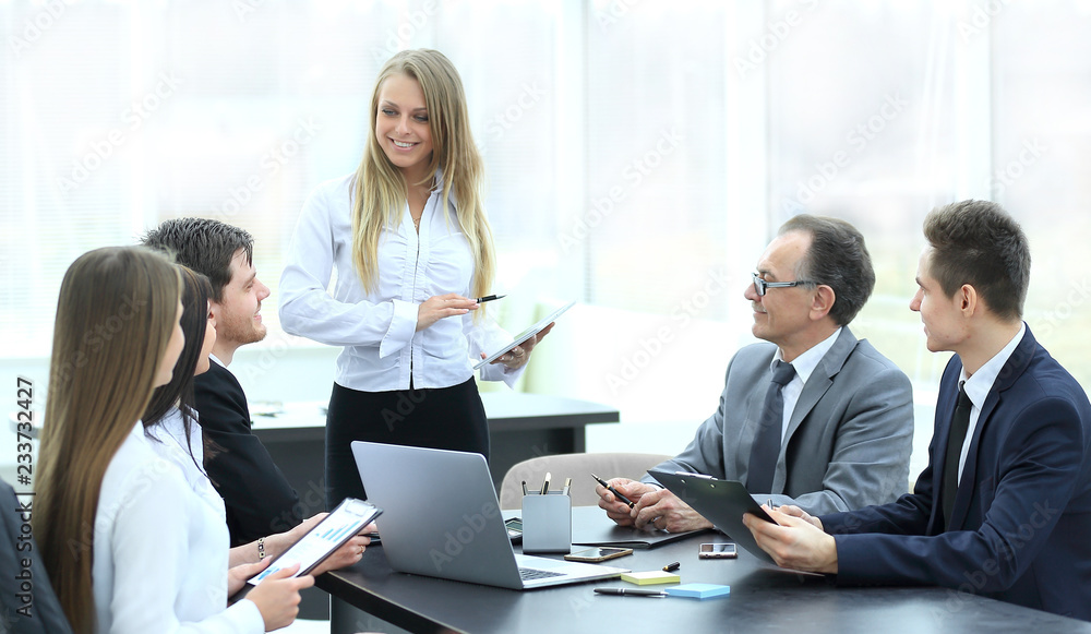 Businesswoman explaining business plan to her colleagues Businesswoman explaining business plan to her colleagues