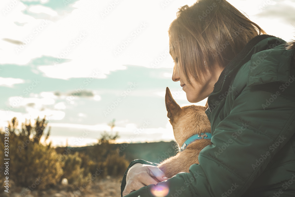 Portrait of a dog and a young woman in the country .Concept of love between dog and person Portrait of a dog and a young woman in the country .Concept of love between dog and person