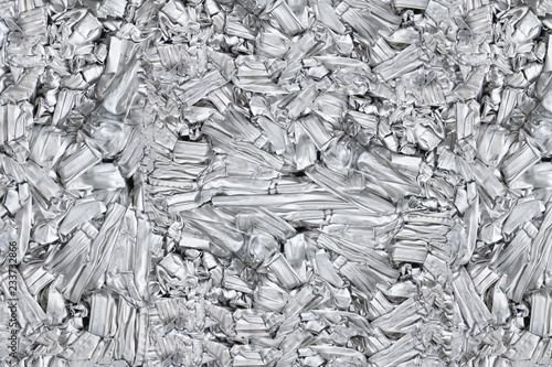 pressed aluminum scrap background and texture, silver metal recycling. photo
