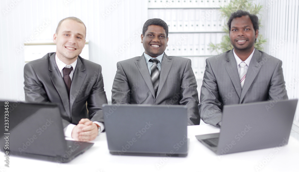 business partners sitting at your Desk in the office business partners sitting at your Desk in the office