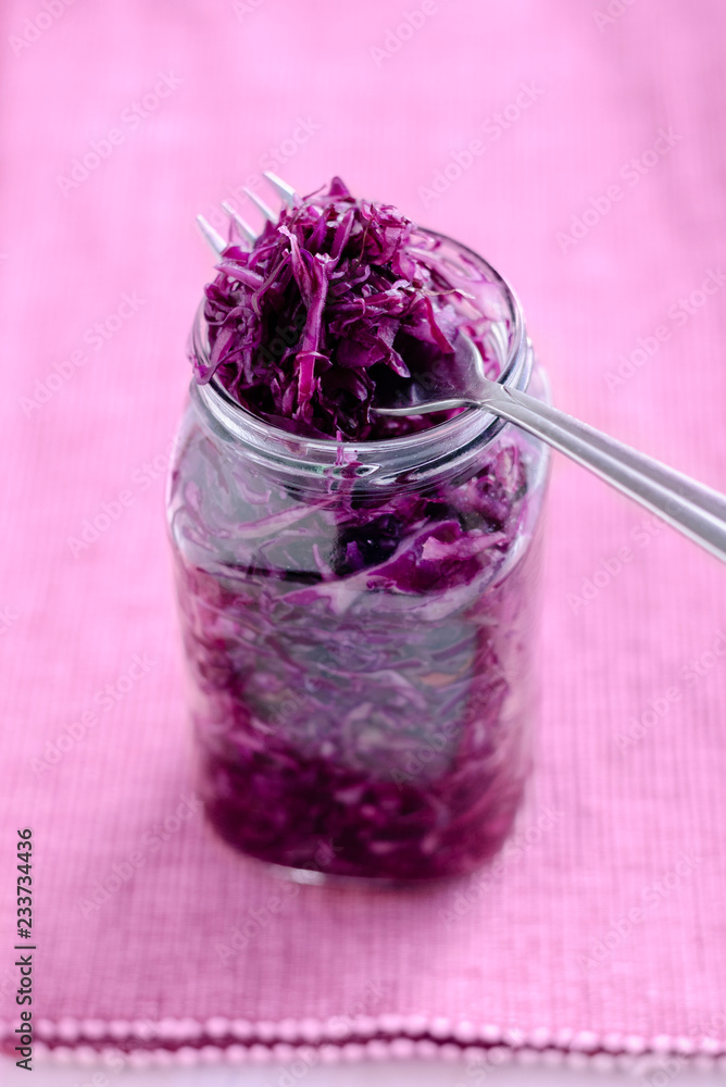 Fork on jar with purple sauerkraut Fork on jar with purple sauerkraut
