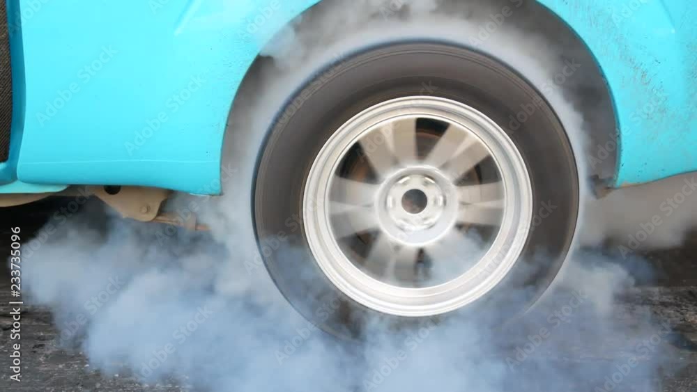 Drag car make tires warm up with smoke, Car racing burnout rubber off its tires in preparation for the race. Drag car make tires warm up with smoke, Car racing burnout rubber off its tires in preparation for the race.