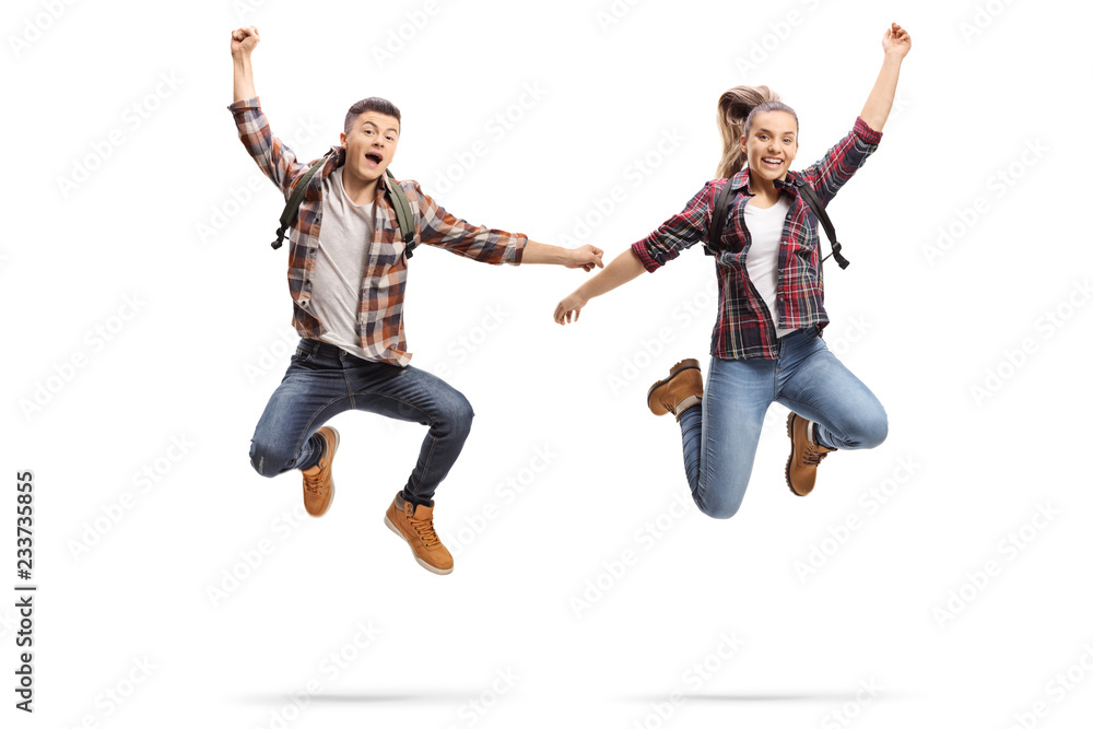 Happy male and female students jumping Happy male and female students jumping