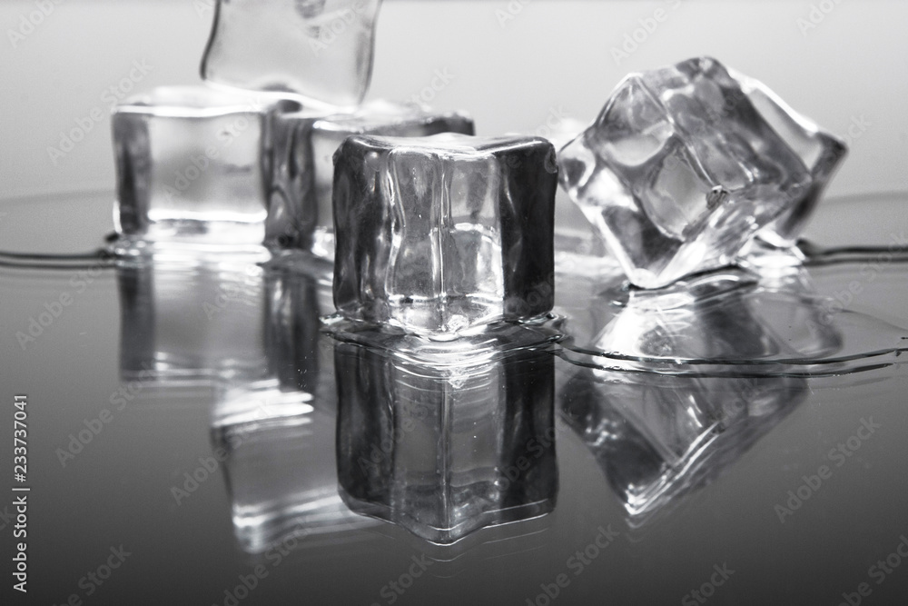 Ice cubes on a reflective surface Ice cubes on a reflective surface
