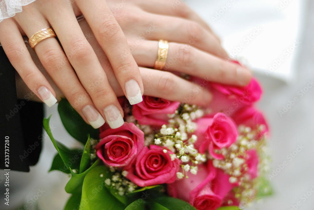 wedding rings. bridal bouquet of fresh roses on the table. wedding floristry, floristic decorative statement wedding rings. bridal bouquet of fresh roses on the table. wedding floristry, floristic decorative statement