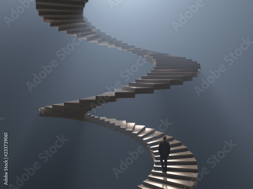 man climbs the spiral staircase photo