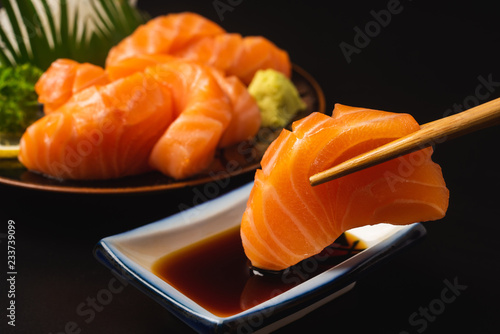 Sashimi, Salmon, Japanese food chopsticks and wasabi on the table