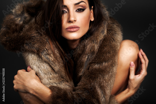 Young woman in brown fur coat
