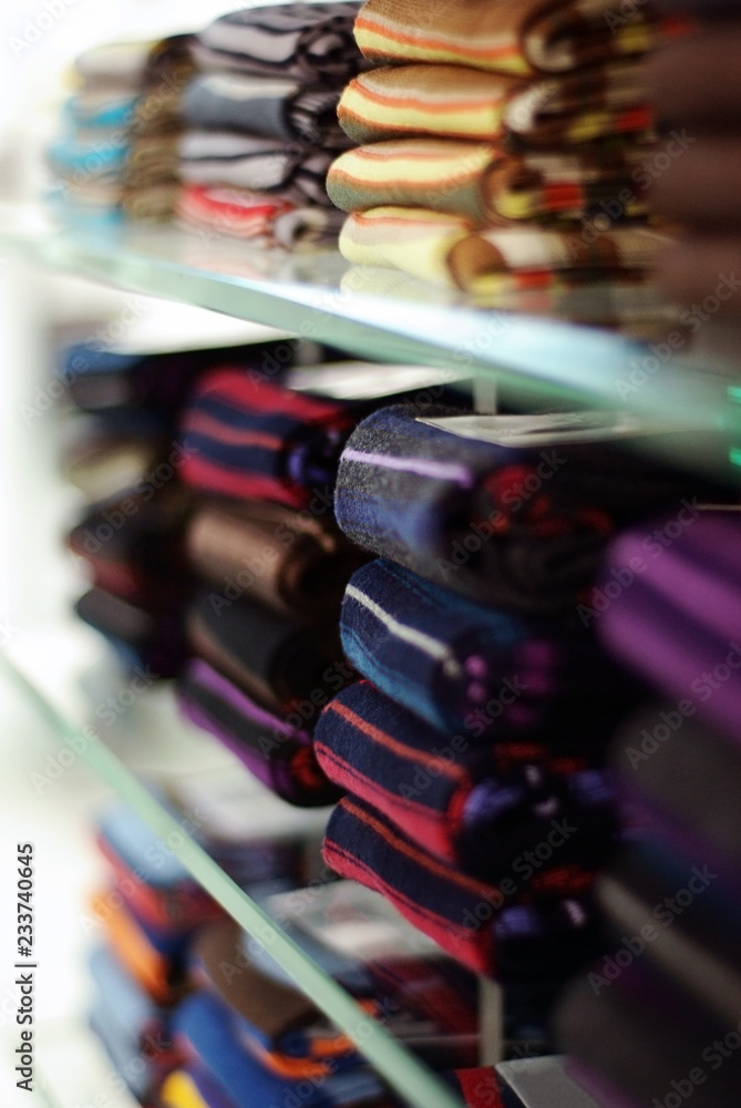 Fototapeta socks on glass shelves in a shop selective focus