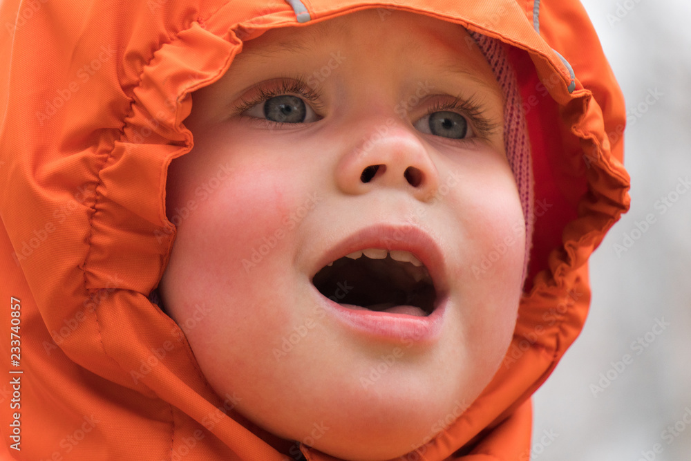 Portrait of a crying child in a hood and warm clothes on a winter day Portrait of a crying child in a hood and warm clothes on a winter day