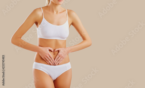 Woman's hands on the stomach