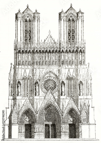 Ancient isolated typical gothic facade of a french cathedral rich of detailed sculptures and spiers. Old view of Reims, France. By unidentified author published on Magasin Pittoresque Paris 1839