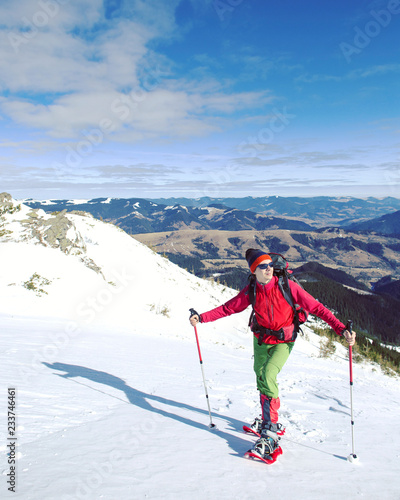 Winter hiking in the mountains with snowshoes.