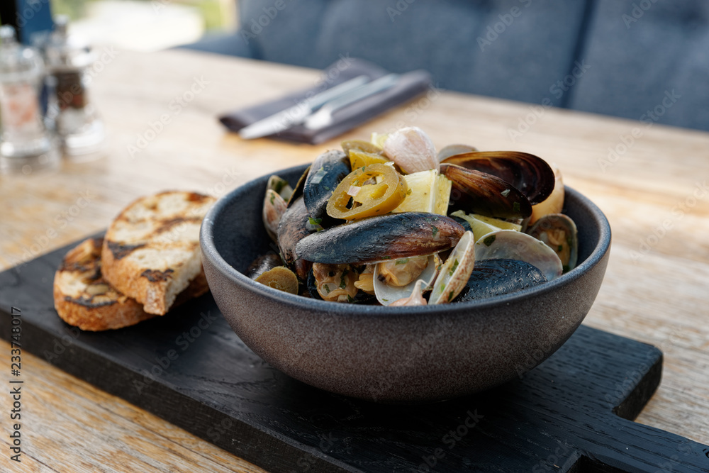Clams and mussels stew with grilled bread Clams and mussels stew with grilled bread