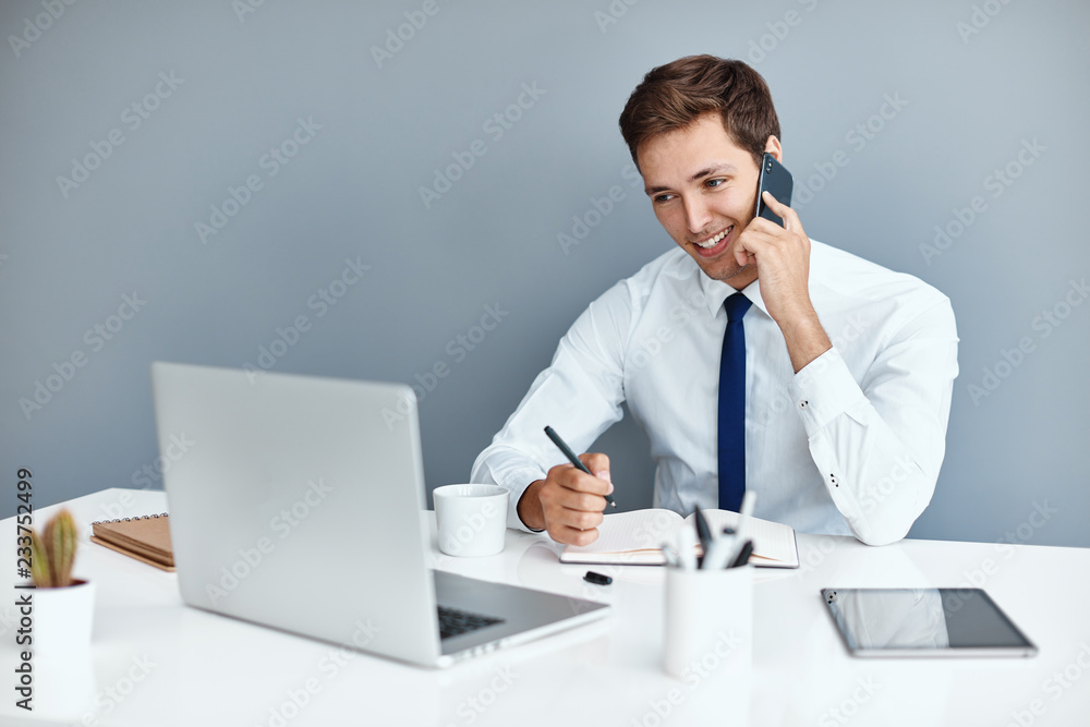 Young successful businessman on his work place Young successful businessman on his work place