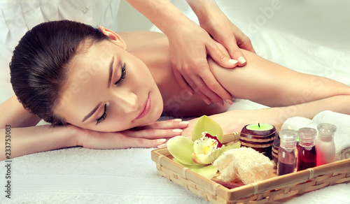 Massage and body care. Spa body massage woman hands treatment. Woman having massage in the spa salon for beautiful girl 