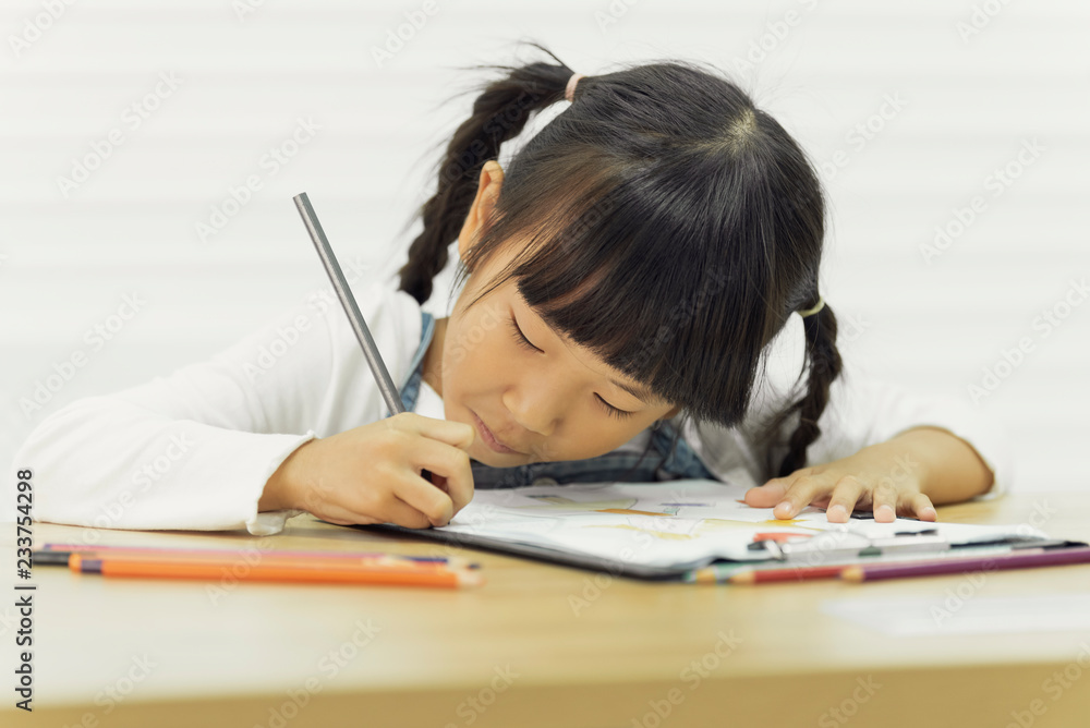 Asian child drawing paint on table in school Asian child drawing paint on table in school