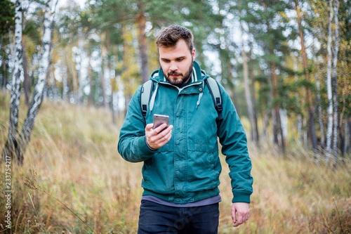 Man checking map on phone while hiking © Анна Волгина