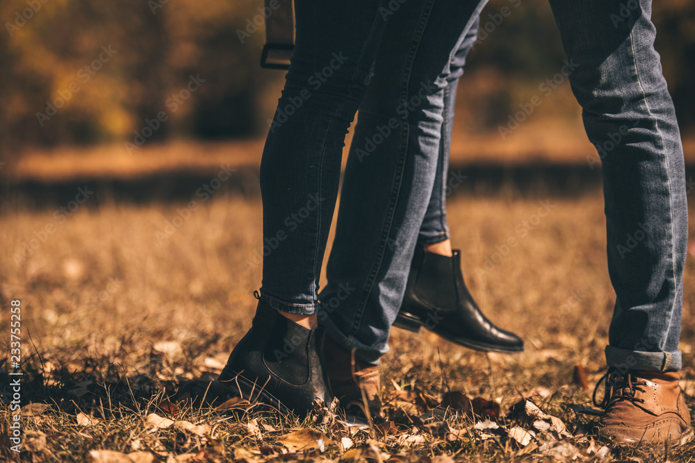 Amorous couple standing on the green grass