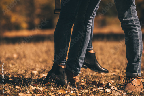 Amorous couple standing on the green grass