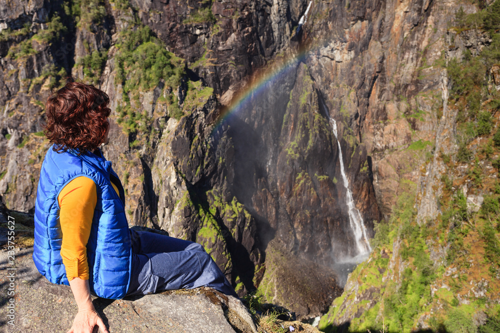 Naklejka premium Tourist woman by Voringsfossen waterfall, Norway