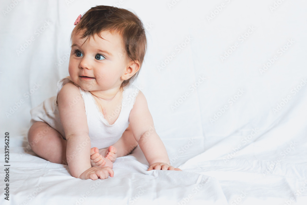 beautiful baby girl with long hair sitting on white background beautiful baby girl with long hair sitting on white background