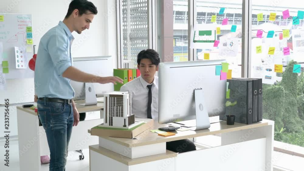 Architects male and Businessman unhappy project and unfinished working on building model. Business man suggest idea to designer at modern office. concept of construction, architecture. Architects male and Businessman unhappy project and unfinished working on building model. Business man suggest idea to designer at modern office. concept of construction, architecture.