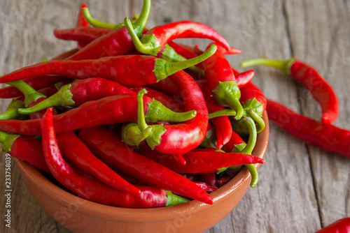 Hot chili peppers on wooden background