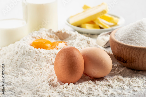 Ingredients for dough and pastry on wooden table, close up on eggs.
