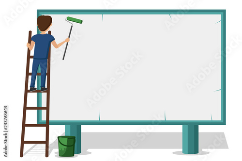 Advertising worker putting up posters on the Billboard. Standing on the mounting ladder.