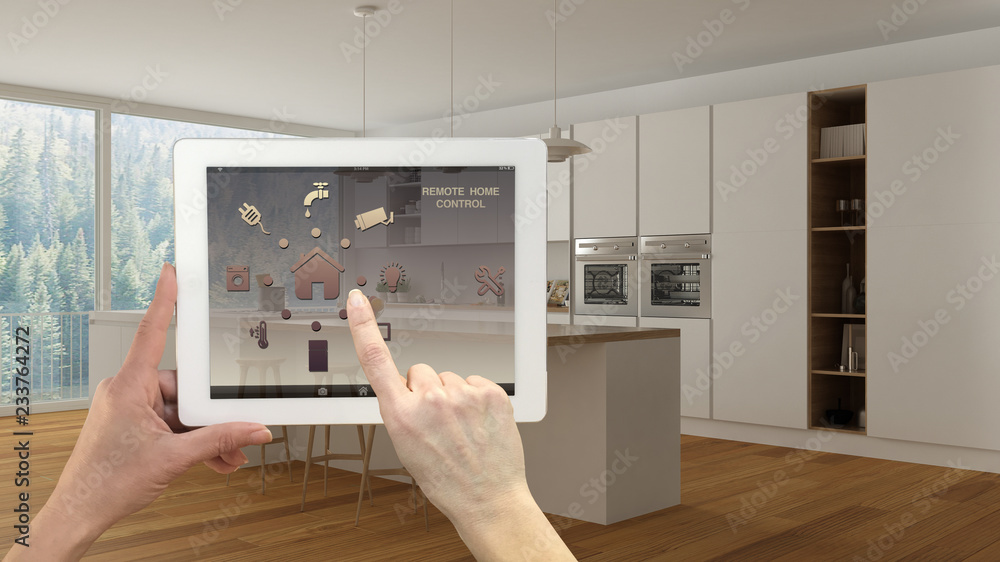 Smart remote home control system on a digital tablet. Device with app icons. Modern minimalist white and wooden kitchen in the background, architecture interior design Smart remote home control system on a digital tablet. Device with app icons. Modern minimalist white and wooden kitchen in the background, architecture interior design
