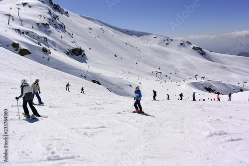 Skiers riding from the tops of the Sierra Nevada