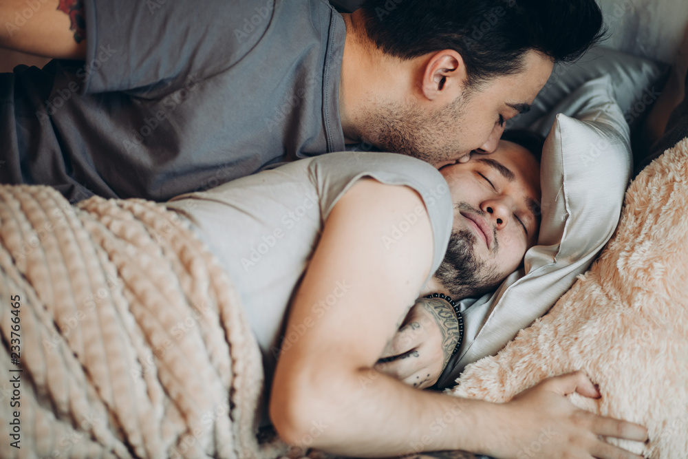 High Angle View Of Sweet Homosexual Gay Couple Sleeping Together In Bed