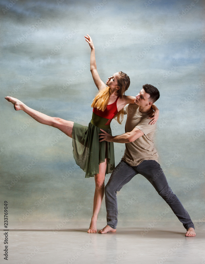 Obraz premium Two people dancing in contemporary stile of ballet at studio on gray