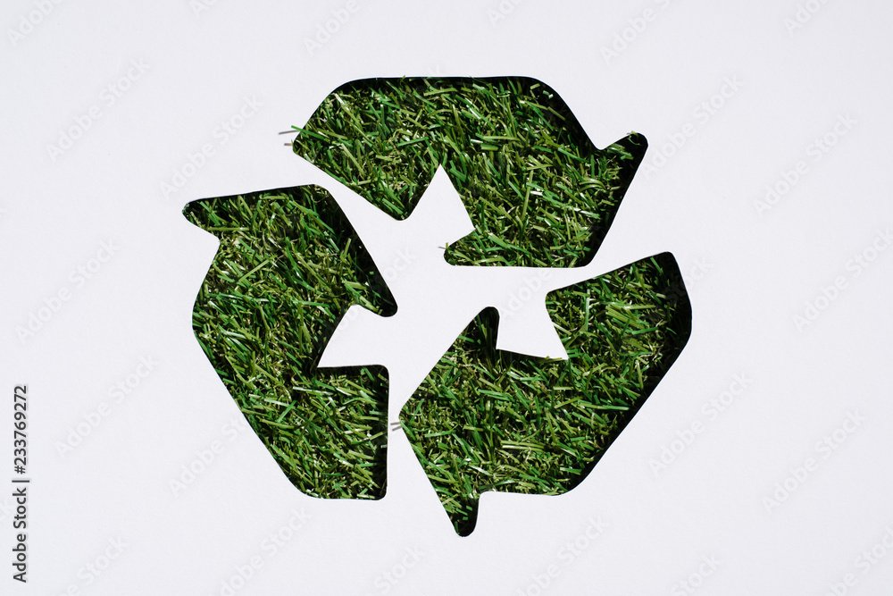 Top view of recycle sign with grass patern isolated on white Top view of recycle sign with grass patern isolated on white