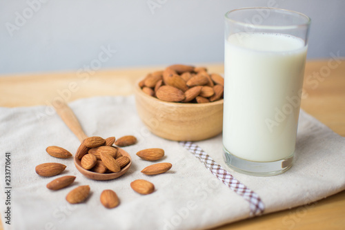 almond and milk on wooden table. soft focus.