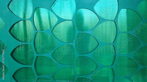 Translucent green wall with abstract geometric pattern photo