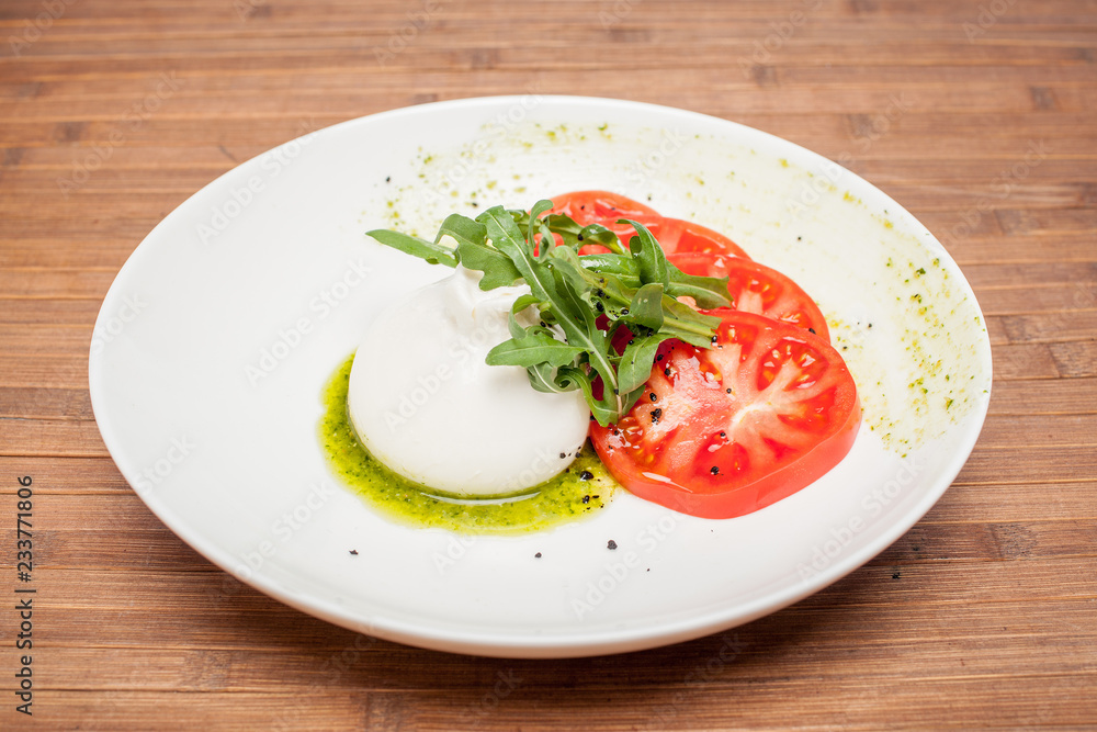 Buratta dish on a wooden background Buratta dish on a wooden background