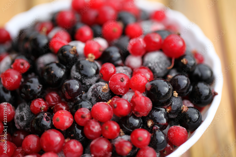 Frozen mixed berries as background. Currant mulberry texture pattern. Diet vegetarian food in winter. Frozen mixed berries as background. Currant mulberry texture pattern. Diet vegetarian food in winter.