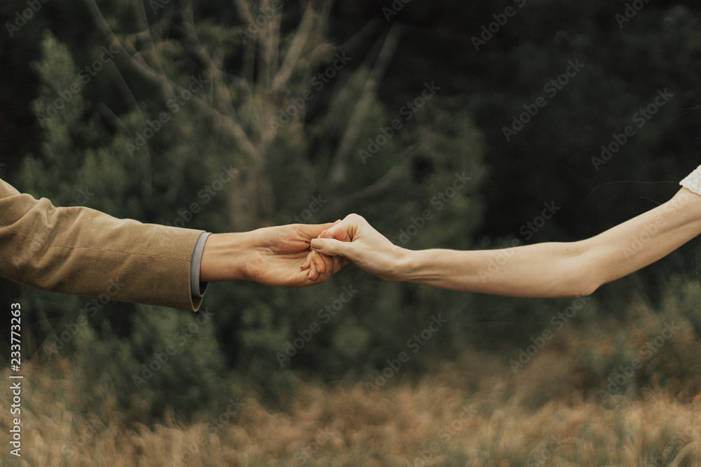 couple holding hands in park