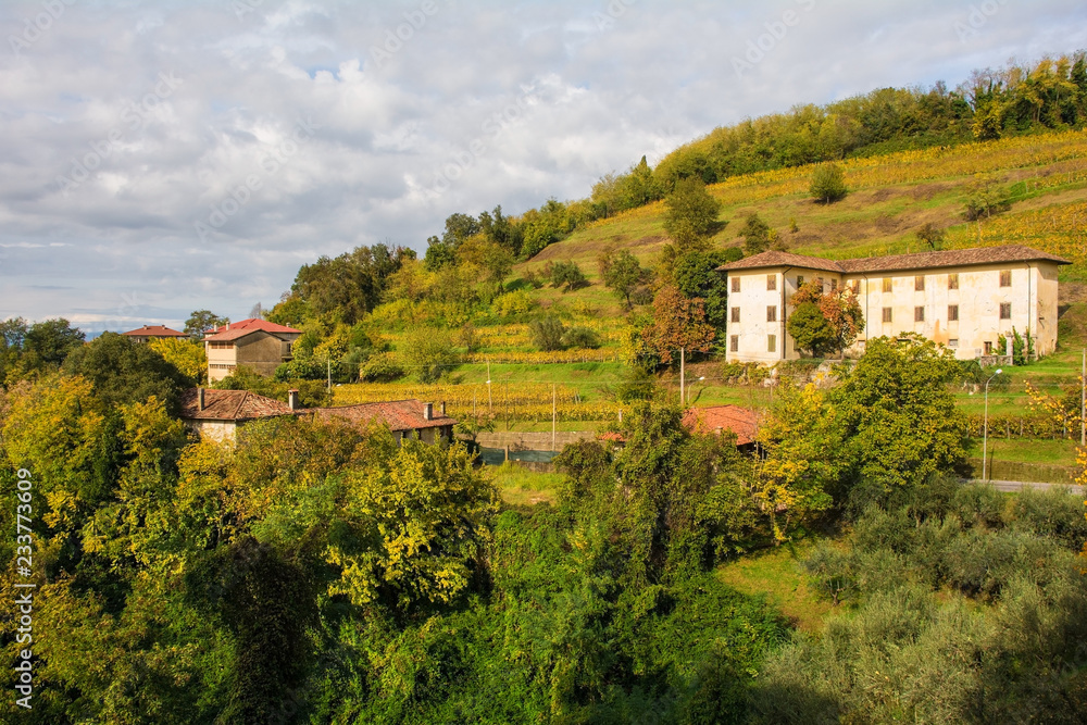 The autumn landscape in the Collio vineyard area of Friuli Venezia Giulia, north west Italy, showing a statue from the historic Abbazia di Rosazzo Abbey

