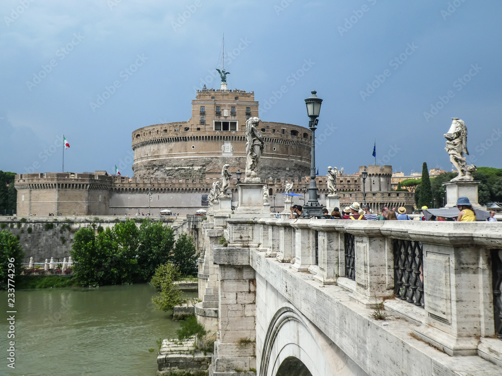 Castle of the Holy Angel in Rome, Italy (Italian Castel Sant'Angelo), or Mausoleum of Hadrian, a towering cylindrical building in Parco Adriano, from the Angel bridge at the Tiber river