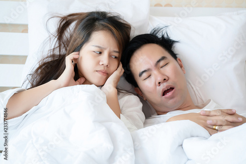 Canvas Print Couple on bed with white mattress Man snoring loud makes women feel annoyed
