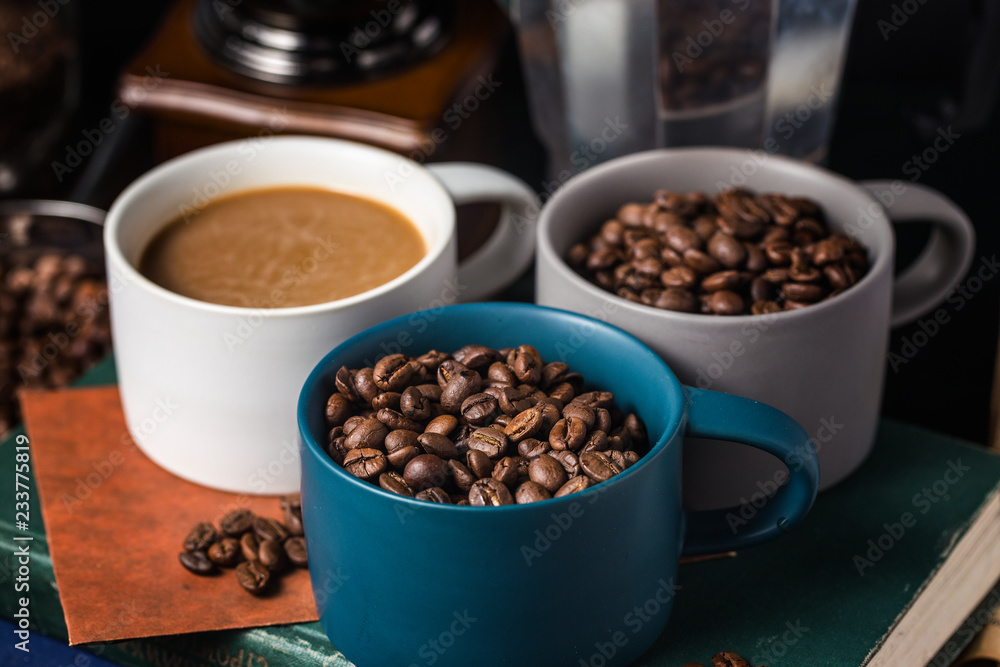 Fototapeta premium Coffee cup and beans on old kitchen table.