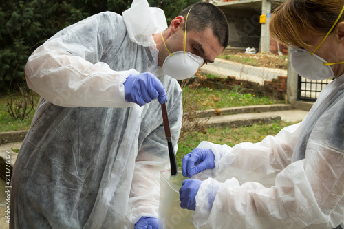 A forensics team collects proofs. Crime scene